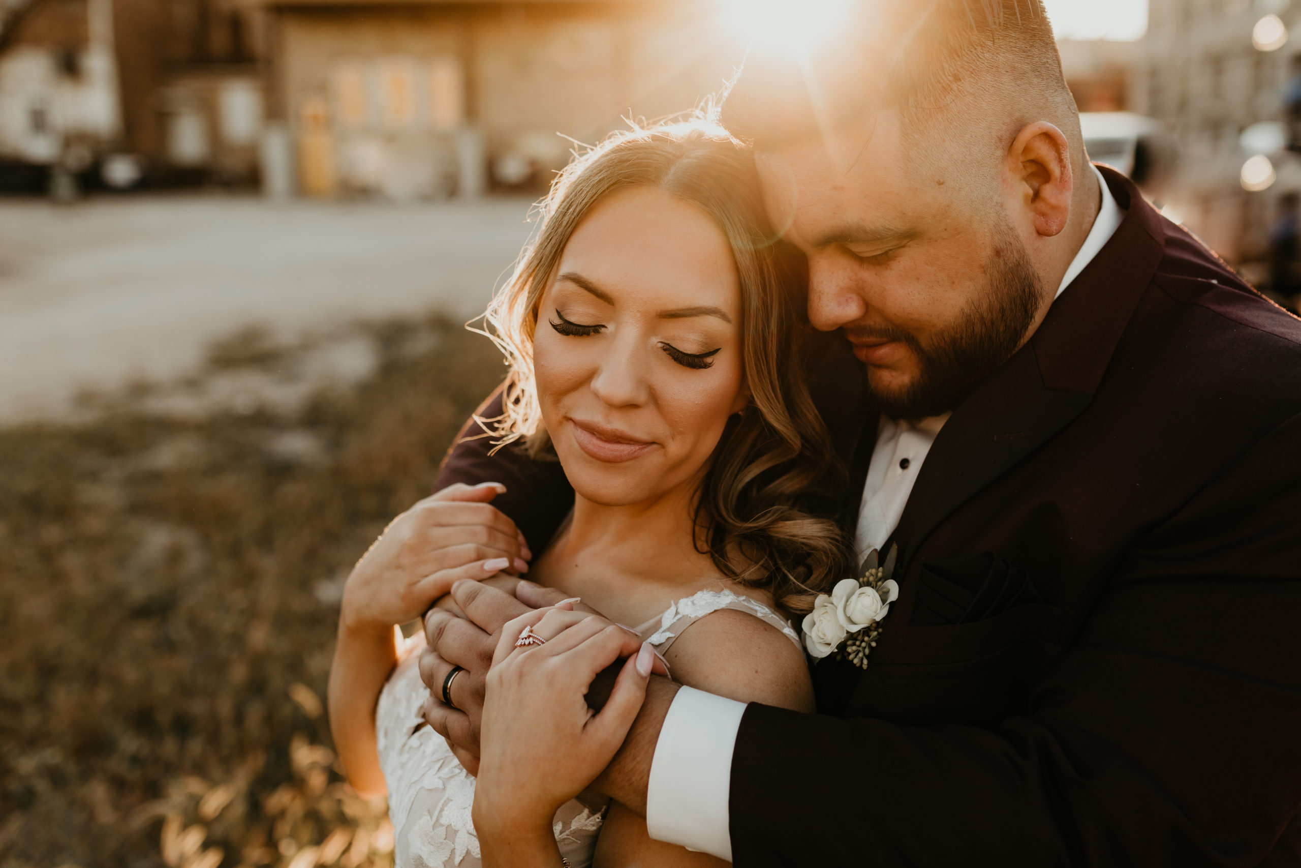 Wedding couple snuggled during golden hour