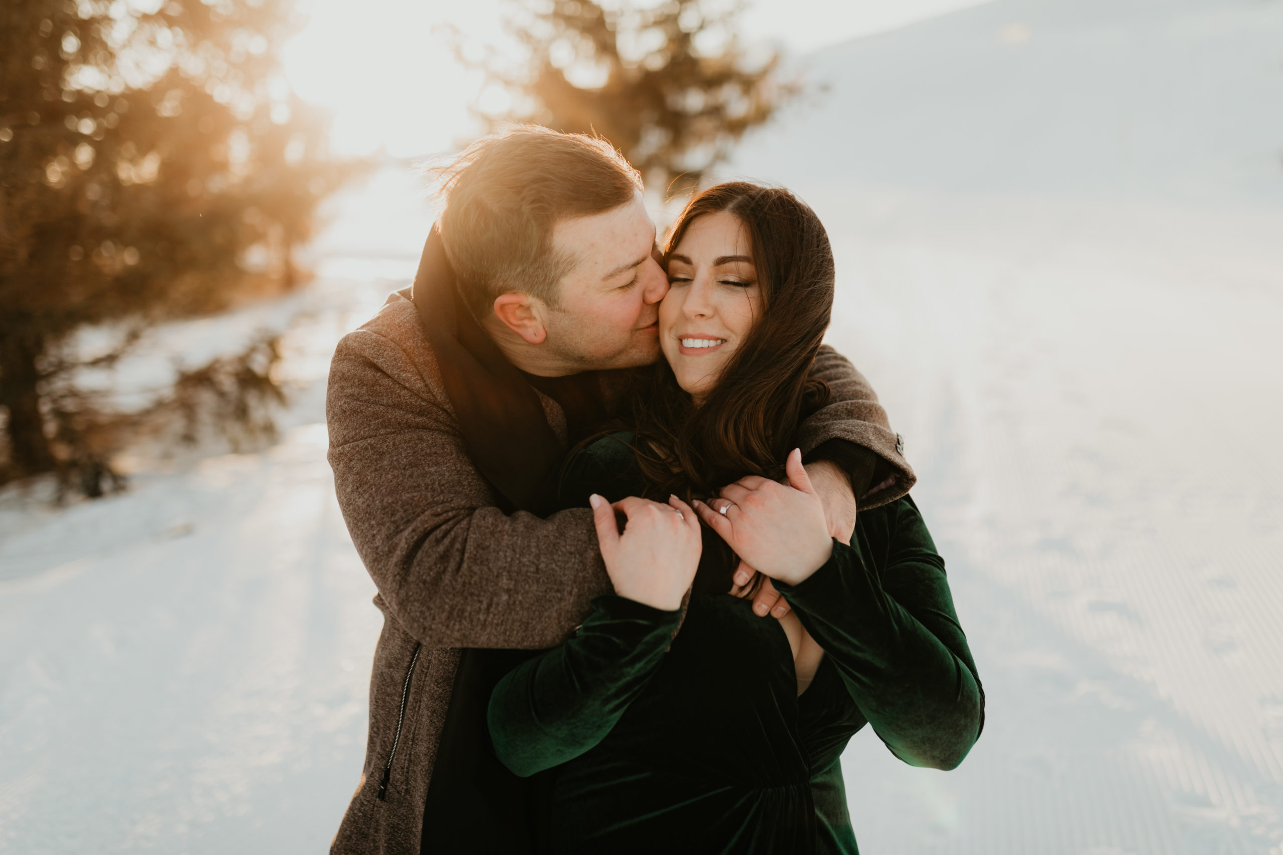 winter engagement session with couple in snowy sunset